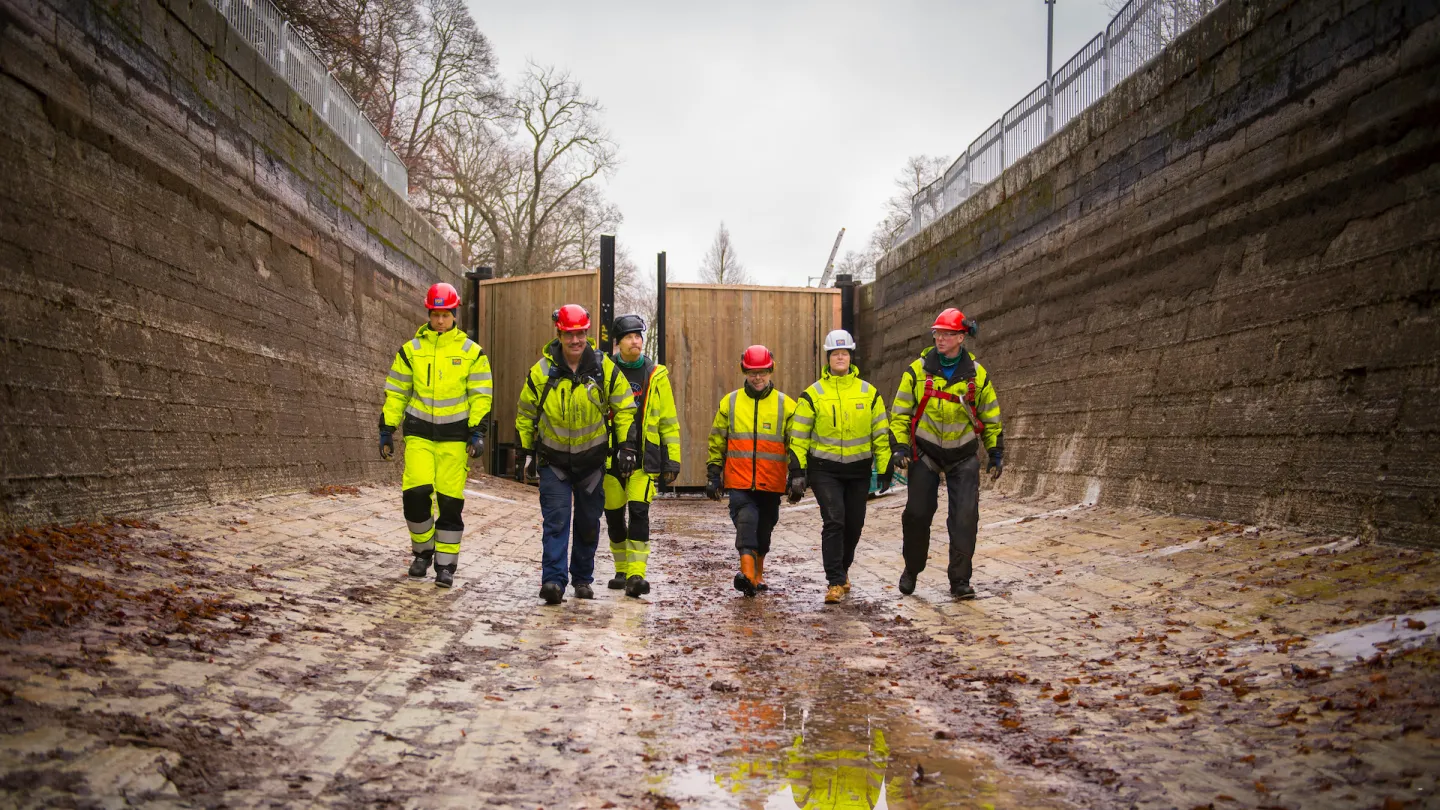 Kanalreparatörer på botten av en tömd sluss